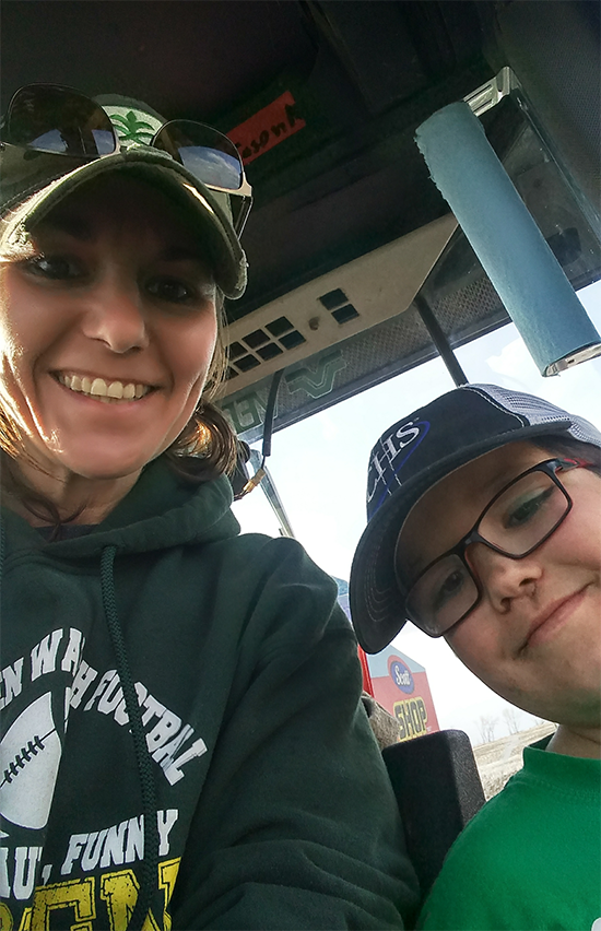 Carie and her son in the tractor cab