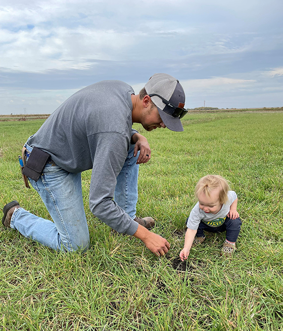 Luke and his daughter check the crops