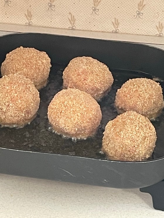 Scotch eggs in frying in oil