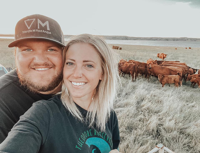 Blake and Whitney Wold and their red Angus cattle