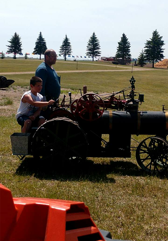 Driving a mini-steamer at the Dale and Martha Hawk Museum