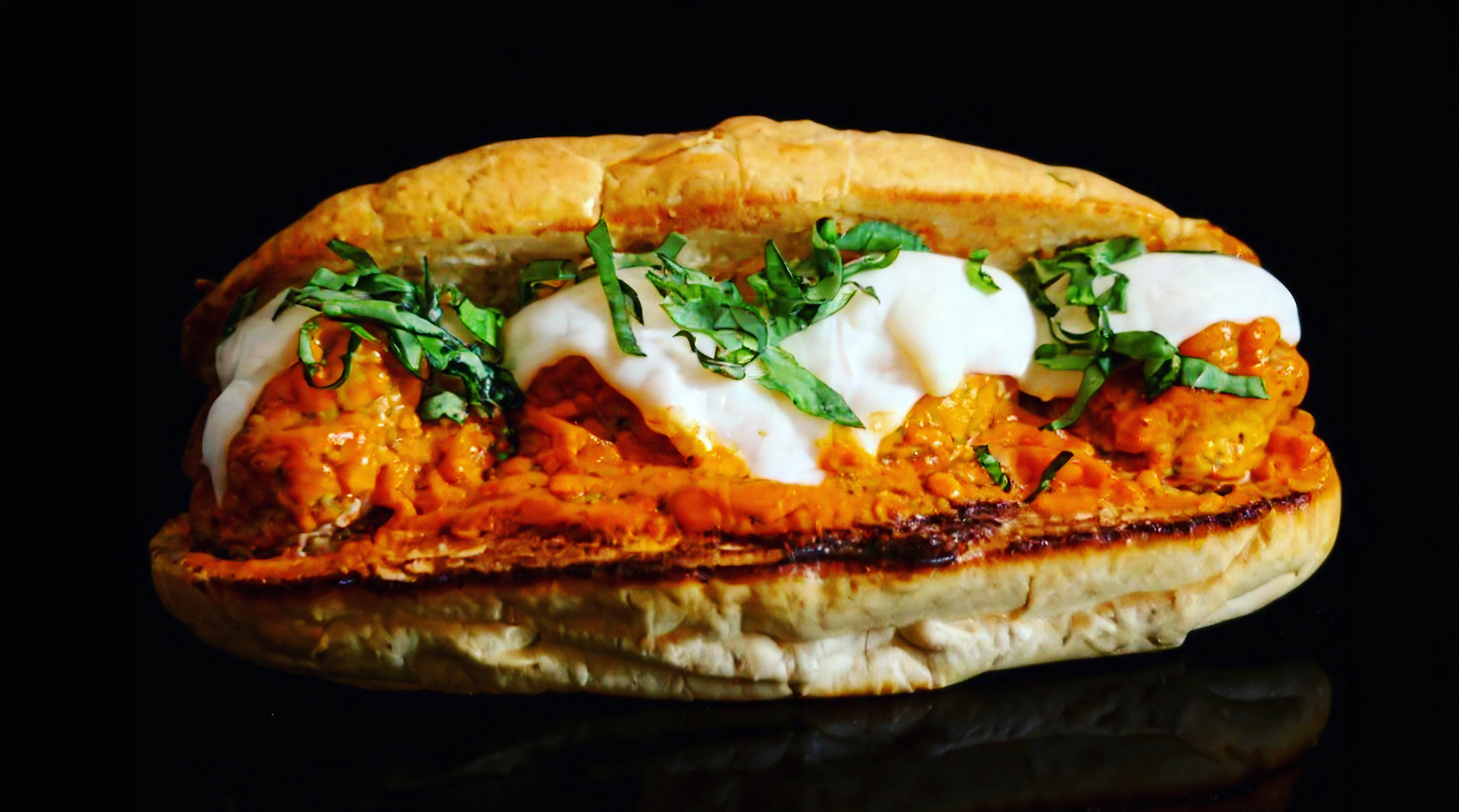 Homemade meatball subs with fresh basil marinara